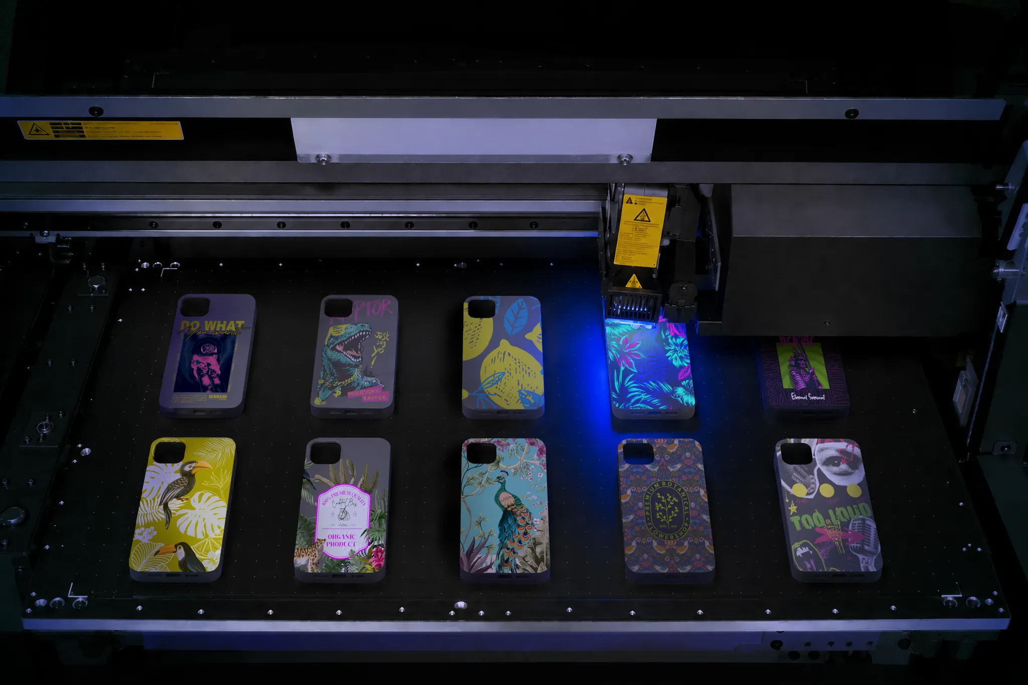 Original Mimaki photograph showing decorated phone cases on the printer bed